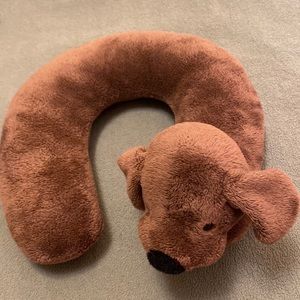 Eddie Bauer children’s travel neck pillow it’s a brown dog w/black eyes and nose